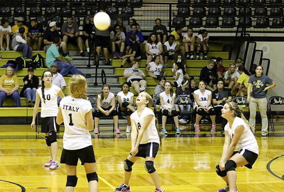 Image: Oh, the humanity: Karley Nelson(8) bumps the ball back to Frost as teammates Madison Galvan(10), Tatum Adams(1) and Cassidy Gage(14) react.