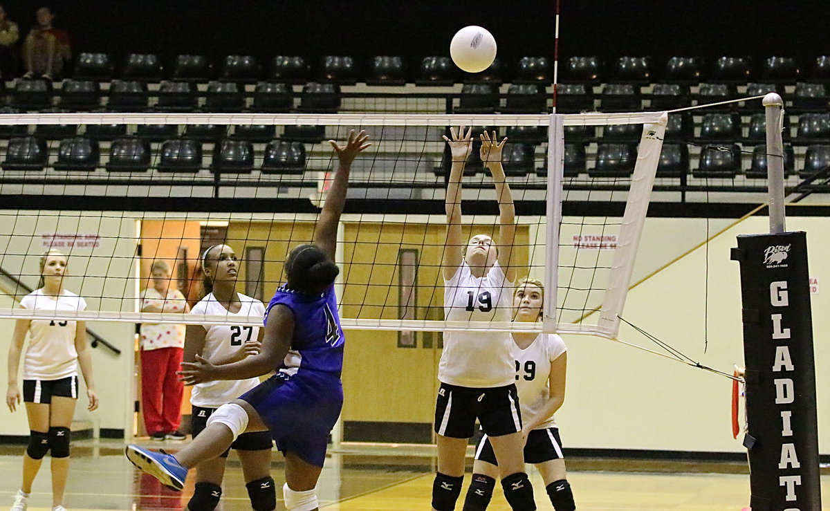 Image: Kirby Nelson(19) gains air to help keep Frost from scoring as Emmy Cunningham(27) and Grace Haight(29) back her up.