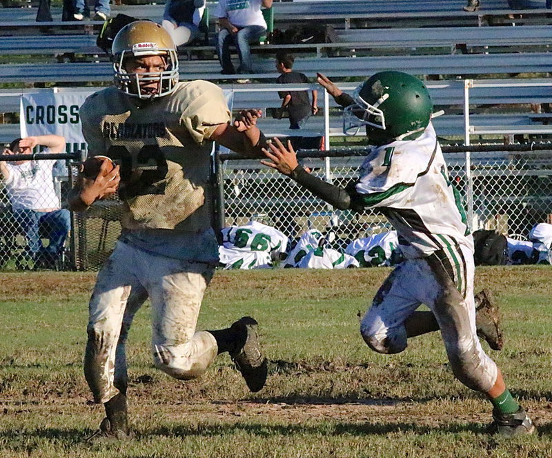 Image: Italy 7th grader Jonathan Salas(22) avoids a Crossroads defender while plotting his course across a muddy Willis Field.