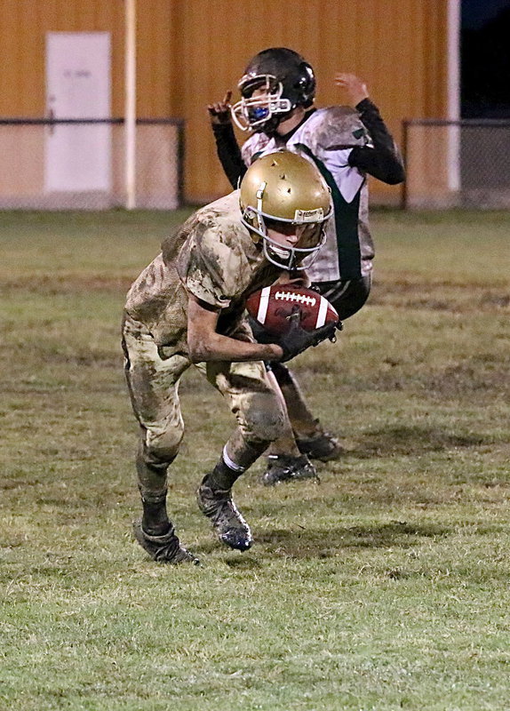Image: Italy 8th grader Garrett Janek(8) intercepts a Bobcat pass and knows what to do with it.