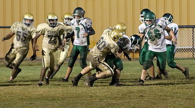Image: Italy 8th grader Clay Riddle(60) clamps down on a Bobcat in the backfield.
