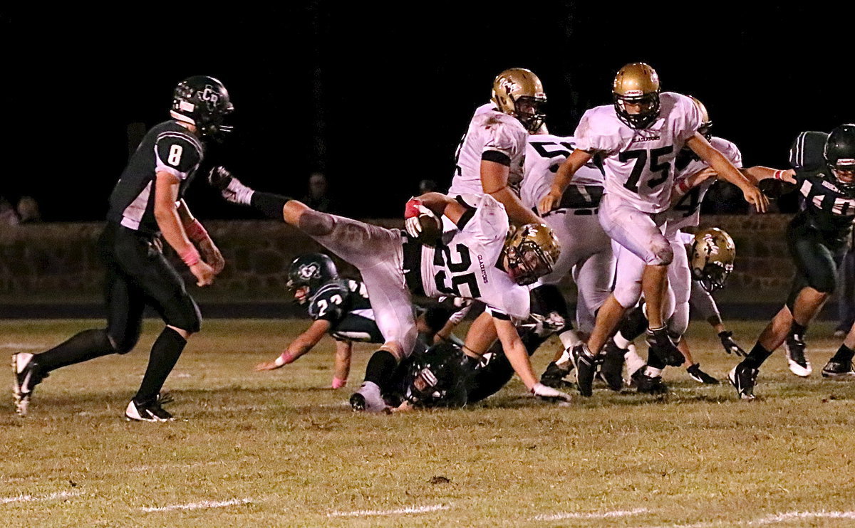 Image: Gladiator fullback Shad Newman(25) keeps his balance for extra yardage.