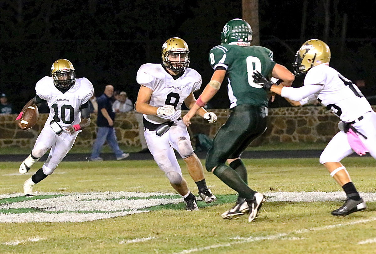 Image: TaMarcus Sheppard(9) gets a kick out block from tight end Levi McBride(85) as he follows backfield mate Hunter Merimon(9) thru the crease.