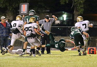 Image: Top Bobcat back, Raleigh Seilheimer(5), a senior, dives across the tip of the goal line for a 2-point conversion.