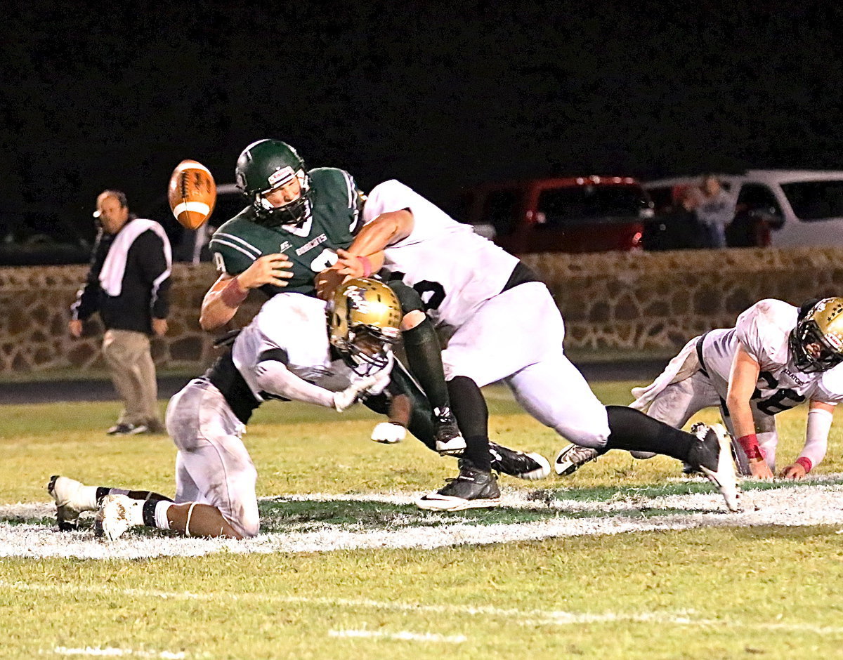 Image: The face of Bobcat QB #8 Aaron Arden tells it all as senior safety Trevon Robertson(8) teams with junior tackle John Byers(56) who pops the ball out from behind.