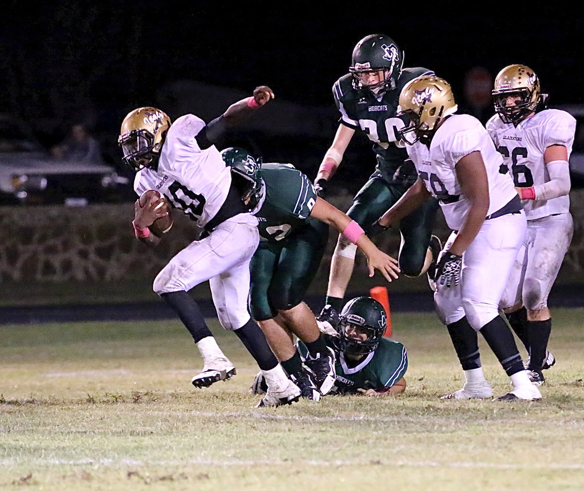 Image: Eluding Bobcat tacklers is Gladiator quarterback TaMarcus Sheppard(10).