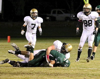 Image: Inside linebacker Kyle Fortenbery(66), a junior, makes the tackle for Italy.