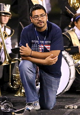 Image: Gladiator Regiment Band director Jesus Perez enjoys watching Crossroads’ band perform at halftime.