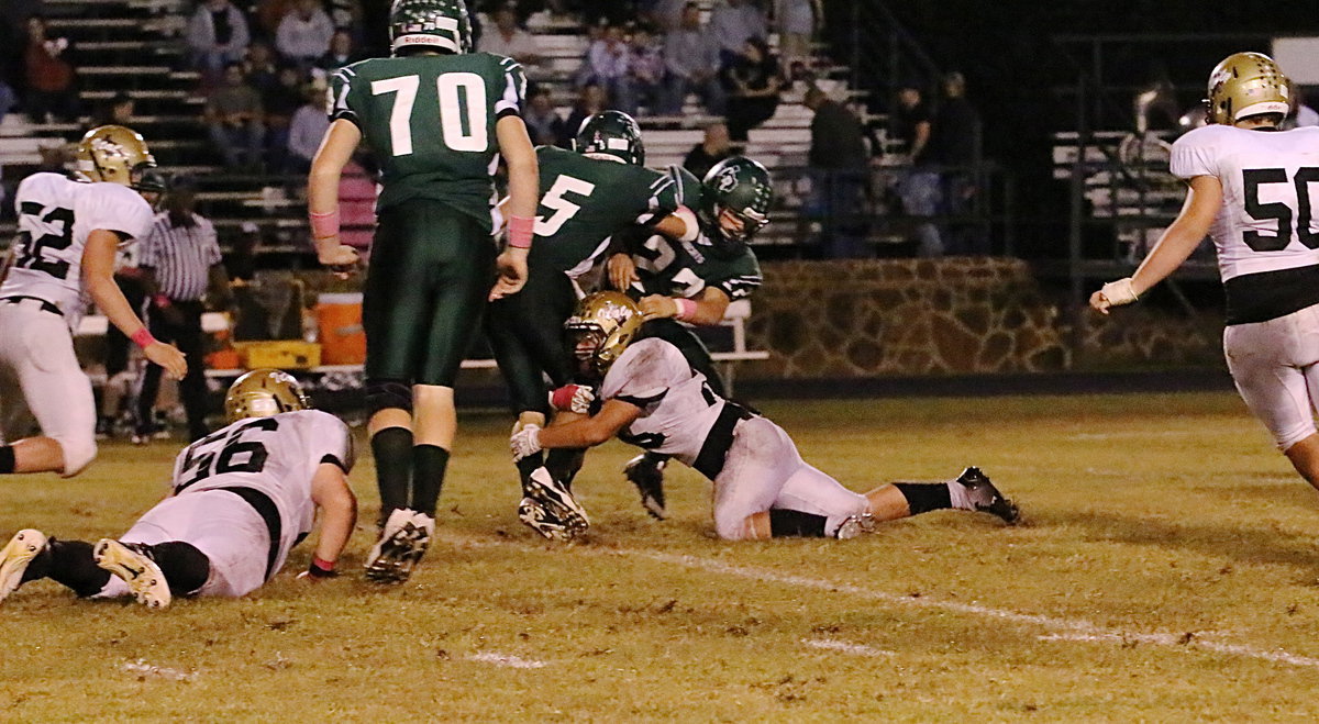 Image: Shad Newman(25) makes a leg tackle to keep the Bobcat run game in check.