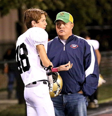 Image: Ty WIndham(48) chats with his father, Joe Windham(Old # 63) after the game.