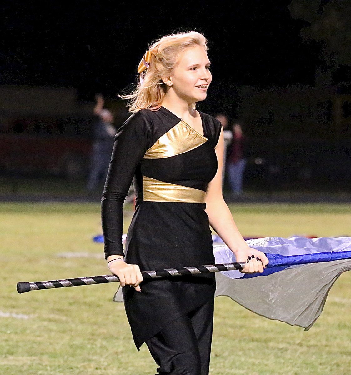 Image: Color guard member Jennifer McDaniel keeps on smiling.