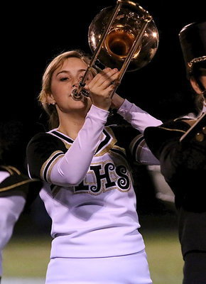 Image: Cheerleader Kelsey Nelson multitasks on the trombone.