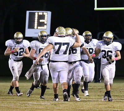 Image: Kicker Kevin Roldan(77) receives some love from John Byers(56), holder Tyler Anderson(36) and the rest of the guys after booting thru 5-out of-6 point-after kicks on the night.
