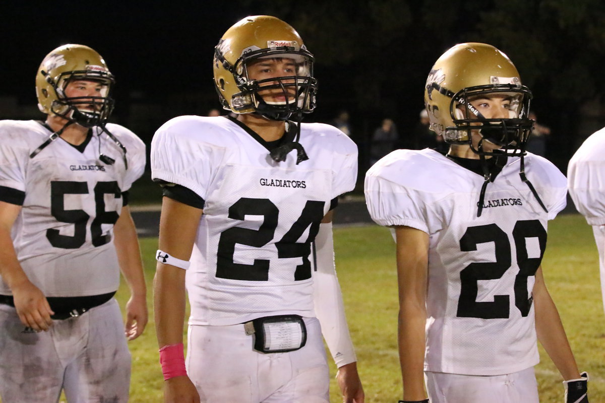 Image: Dylan McCasland(28), Joe Celis(24) and John Byers(56) walk down the midfield stripe to congratulate the Bobcat players on a hard fought effort.