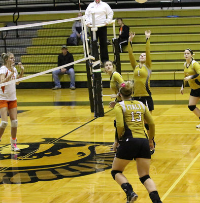 Image: Paige Westbrook(11), Halee Turner(4) and Jaclynn Lewis(13) adjust to the pass from setter Bailey Eubank(1).