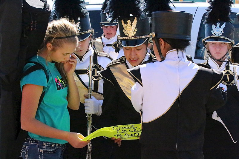 Image: Maegan Connor and Marlen Hernandez read an inspirational card signed by Lady Gladiator Volleyball team members wishing Italy’s band good luck before they take the field.