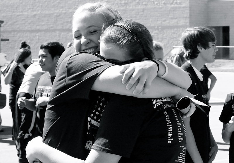 Image: Jaclynn Lewis congratulates Reagan Adams after learning the band is going to Area.
