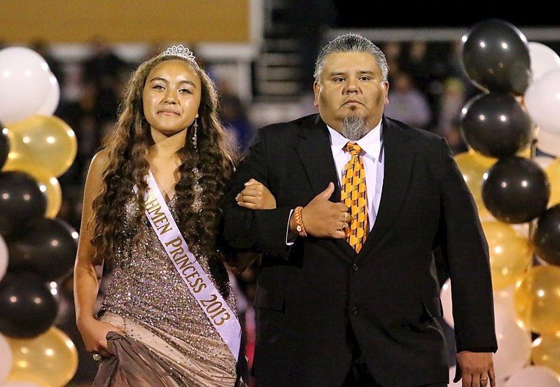 Image: 2013 Freshman Princess, Vanessa Cantu is escorted by her uncle, Armando Cantu, to begin the halftime excitement.