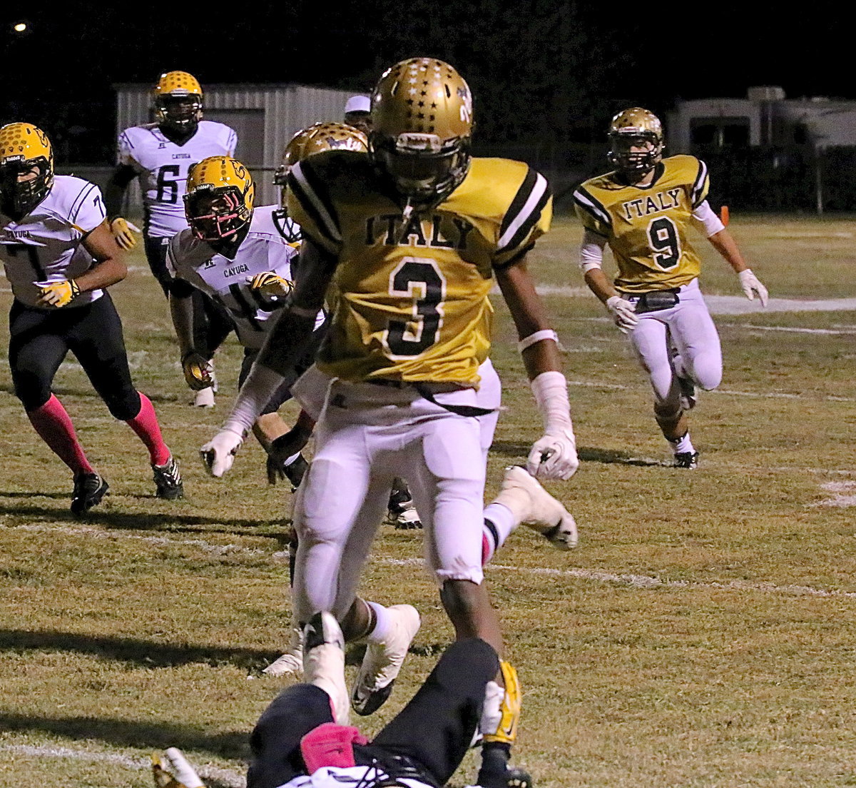 Image: Down Goes Cayuga! Down goes Cayuga! Senior receiver Trevon Robertson(3) flattens a Wildcat defender to help Italy win the match.