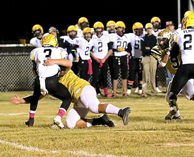 Image: Defensive end Kevin Roldan(60) tackles Cayuga’s top back for a loss in the backfield.