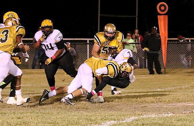 Image: Sophomore Hunter Merimon(9) form tackles a Wildcat for a loss.