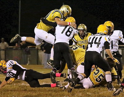 Image: Coby Bland(40) leaps for yardage over a Cayuga tackler.