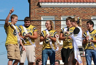 Image: Cheerleader Taylor Turner announces Gladiator Bailey Walton(54) as the chosen king of homecoming. Teammates and fellow nominees Kevin Roldan(60), Shadrach Newman(25), Zain Byers(50) and Tyler Anderson(11) applaud Walton’s success.