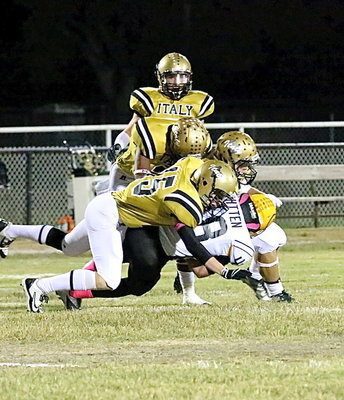 Image: Cody Boyd(15) brings down a Cayuga receiver with help from Tre Robertson(3) and Hunter Merimon.