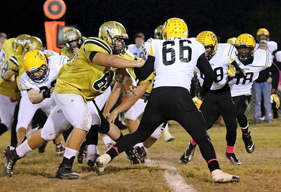Image: Clearing the way for the Gladiator backfield is 280 pound senior tackle Kevin Roldan(60).