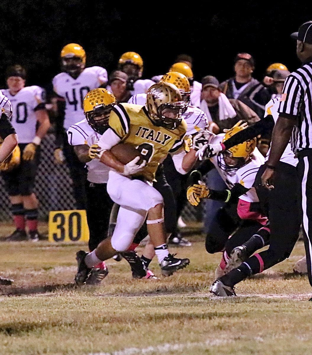 Image: Hunter Merimon(9) darts thru Wildcat tacklers for an Italy 1st down.