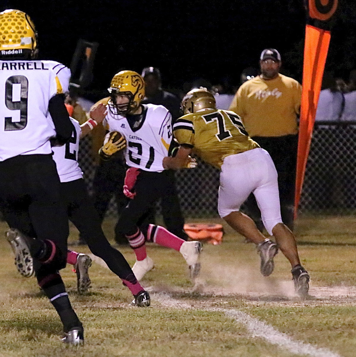 Image: Making a special teams tackle for Italy is senior Cody Medrano(75).