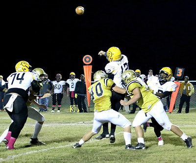 Image: Coby Bland(40) and Zain Byers(50) close in on Cayuga’s quarterback to force an incomplete pass.