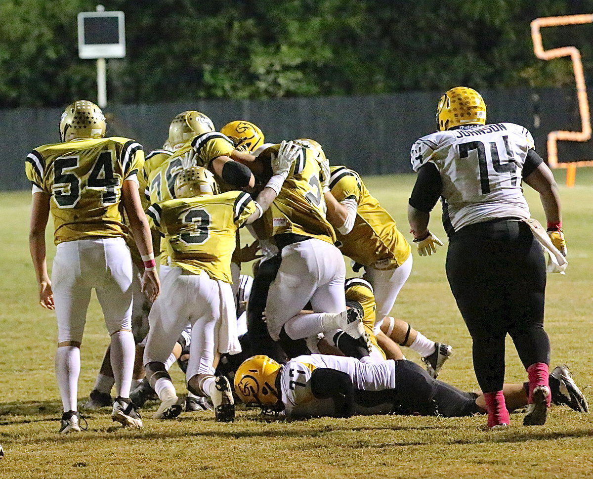 Image: Italy just wanted this win more as Trevon Robertson(3), Colin Newman(76) and Shad Newman(25) join several of their teammates in pushing Cayuga away from the end zone.