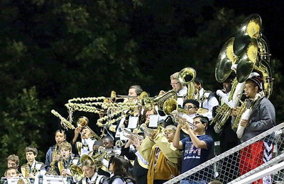 Image: Several band alumni join in the fun including Timothy Fleming on tuba and Reid Jacinto grabbing a trumpet.