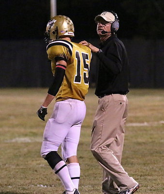Image: Coach Tindol checks the play clock and then sends in a play via tight-end Cody Boyd.