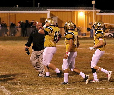 Image: Coach Wayne Rowe compliments Tyler Vencill(65) after the junior lineman recovered an onside kick attempt by Cayuga who was desperate to get back in the game as Tyler Anderson(11), Clayton Miller(6) rush to offer their congratulations.