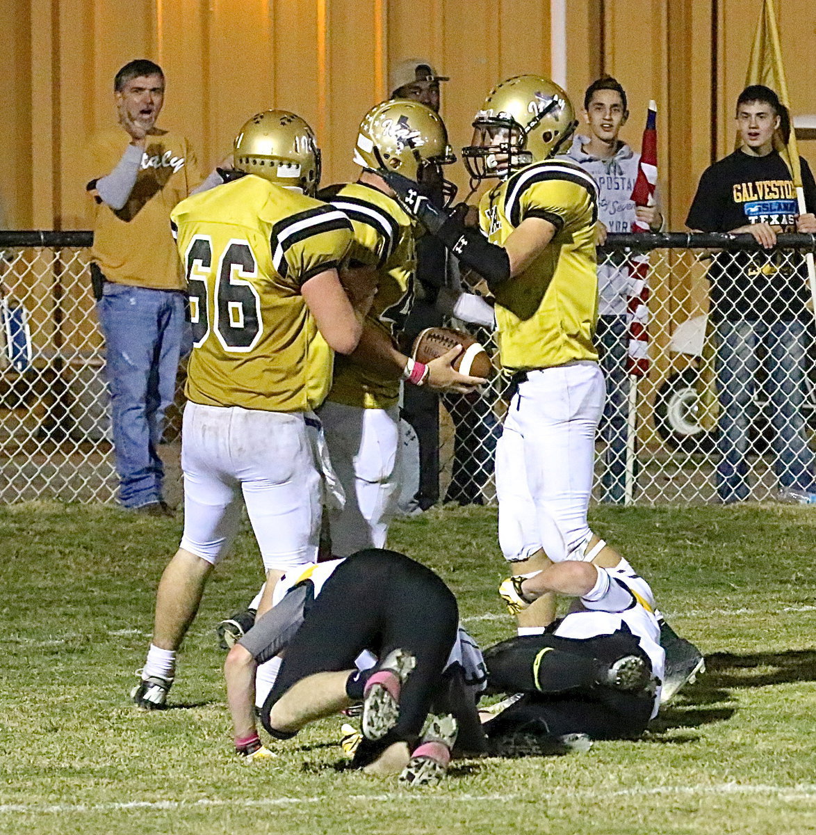 Image: Kyle Fortenberry(66) and Ryan Conor(7) congratulate Coby Bland(40) after he trucks a couple of Cayuga tacklers to score a touchdown.