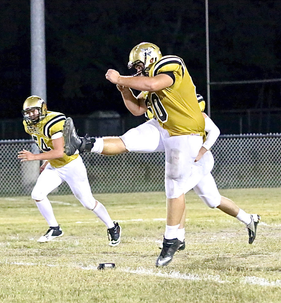 Image: Kevin Roldan(60) kicks off to the Wildcats.