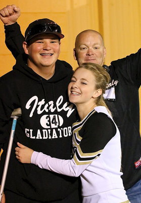 Image: Gladiator junior John “J.B.” Byers celebrates his team’s homecoming victory over Cayuga with cheerleader Britney Chambers and her father Michael Chambers. Byers recorded 2 tackles before exiting the game after the first half.