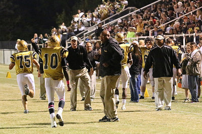 Image: Coaches Larry Mayberry, Sr., Charles Tindol, Wayne Rowe, Brandon Gansky and Bobby Campbell hurry out to greet Cody Medrano(75), Trevon Robertson(3) and TaMarcus Sheppard(10) after Sheppard scored an Italy touchdown.