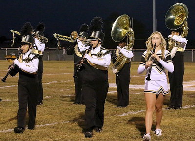 Image: Marlen Hernandez, Jenna Holden and Annie Perry multitask while playing their clarinets.