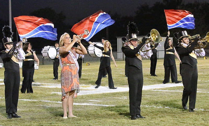 Image: Sarah Burrow, Kayla Cunningham, and Kylee Dabney accent the band’s performance with a wave of their wrists.