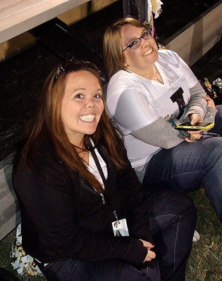 Image: Cheer sponsors Kimberly Watkins (Jr. High) and Catherine Hewitt (Varsity) are all smiles during the homecoming game.