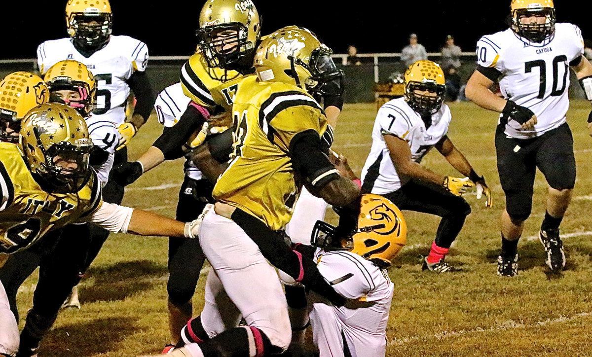 Image: TaMarcus Sheppard(10) runs over a Cayuga defender.