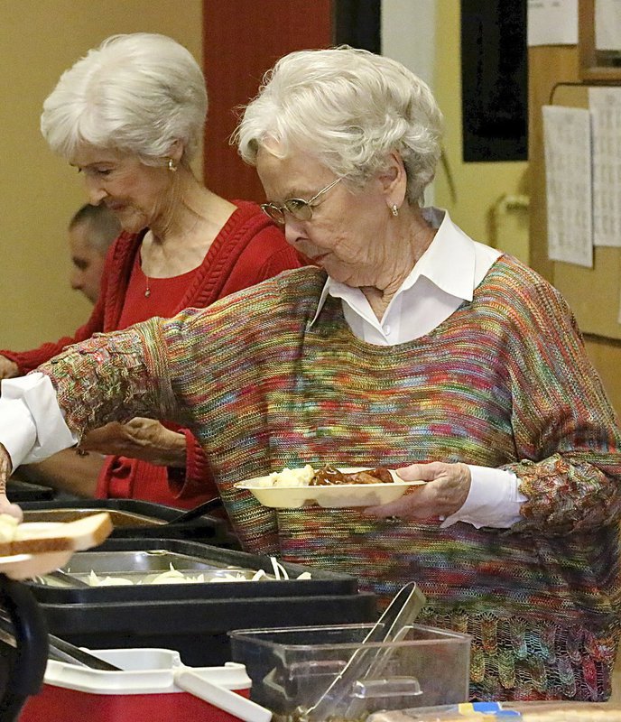 Image: Frances Holley and her sister, Nedra Hooser lend their support while enjoying their meal.