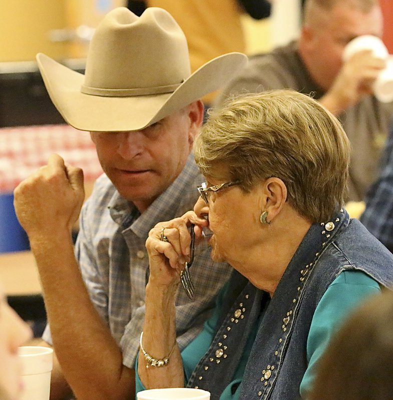 Image: Curtis Riddle chats with Lois Helen Reeves while enjoying the fundraising feast.