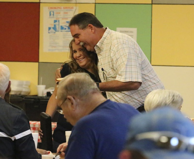 Image: Jerry Smithey gives Jill Varner a big hug.