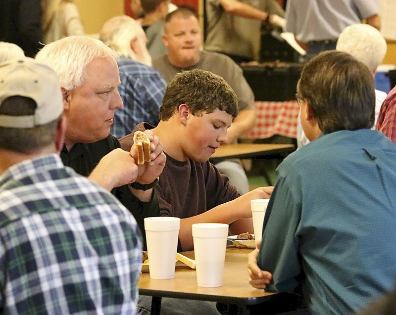 Image: Steven Crowell and son Thomas enjoy Bubba’s brisket.