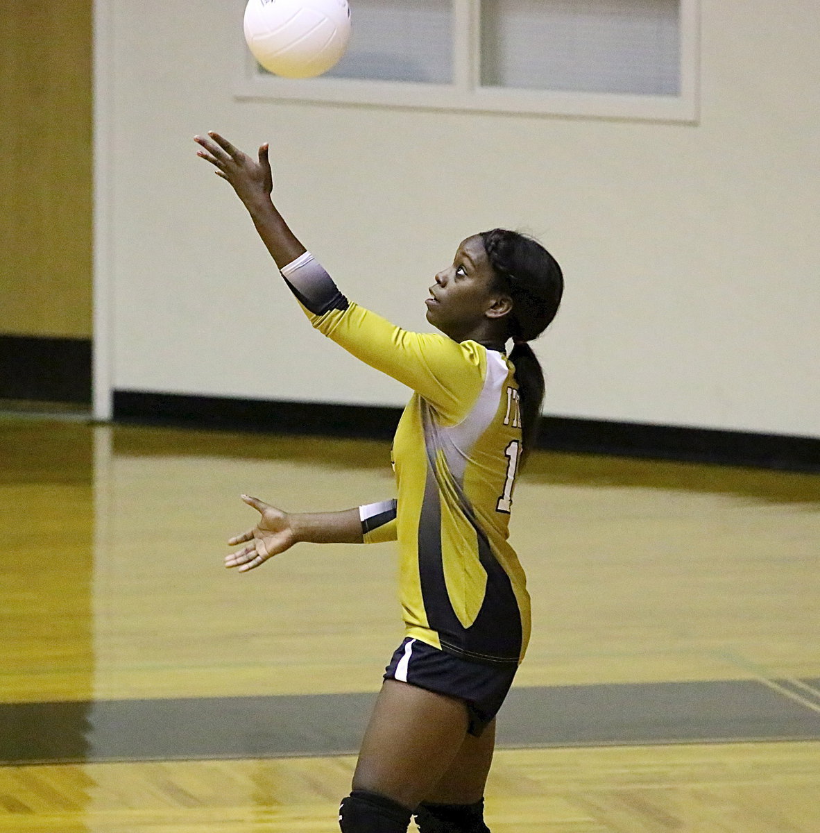 Image: Kortnei Johnson(12) serves to the Lady Polar Bears.