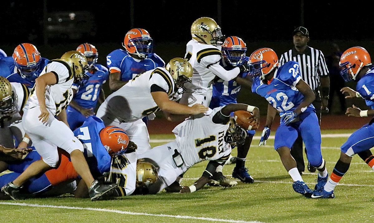 Image: Gladiator Cody Medrano(75), Kevin Roldan(60), Shad Newman(25) and Ryan Connor(7) help teammate and quarterback TaMarcus Sheppard(10) fight for an extra inch.